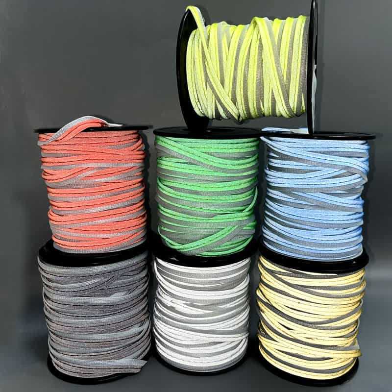 Colored reflective piping and binding tape